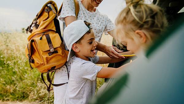 A family are getting into a car.